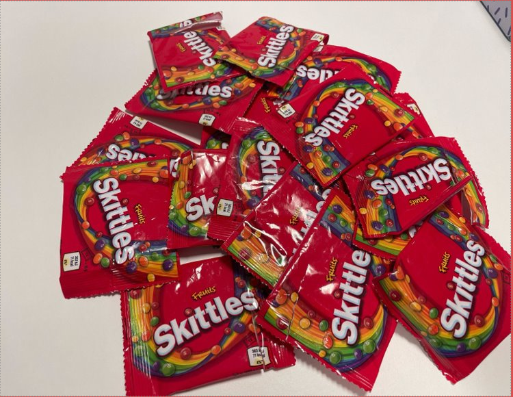 A pile of mini Skittles packets